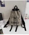Detail of khaki drawstring backpack with front pocket and KOMILO logo on nylon fabric - Small / Single Bag / Khaki