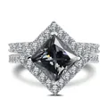 Macro detail of a 3CT princess cut grey gemstone ring with halo pave silver setting - Size 6 / Gray