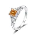 S925 silver ring featuring a princess cut orange gemstone with pavé set accents - Size 5 / Champagne