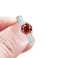 Elegant six-prong silver ring featuring a round red moissanite and double row side stones - Garnet Red