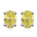 Detailed macro view of yellow oval-cut moissanite studs in S925 sterling silver four-prong setting - 0.5 Carat Style / Lemon Yellow