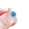 Elegant silver engagement ring featuring a round blue moissanite and 6-prong setting - Sapphire Blue