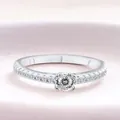 Classic S925 sterling silver ring featuring a round moissanite center stone and pavé accents - US 5 / White 100-Facet Cut