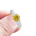 Silver six-prong ring with a round yellow moissanite stone and side diamond accents - Golden