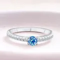 Elegant S925 sterling silver ring featuring a round blue moissanite and micro-pave stones - Sapphire Blue