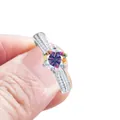 Sterling silver ring with a blue moissanite center stone and pave-set diamond band - AB Multi-color