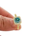 Luxurious gold ring featuring a round cyan moissanite stone in a halo setting - US 5 / Teal