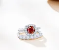 Macro shot of S925 sterling silver ring set with halo red gemstone and side diamonds - Size 5 / Red