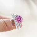 Luxury sterling silver ring set featuring a 6.5ct round pink moissanite and side baguettes - Pink