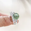 Luxury 925 sterling silver ring set featuring a large green round-cut moissanite stone - Multi-faceted Blue-Green