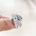 Luxury 925 sterling silver moissanite ring set with round main stone and side diamonds - White