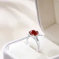 Luxury sterling silver ring with cushion-cut red gemstone and side stones in a velvet box - Garnet Red