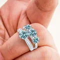 Macro view of 925 silver ring with four light blue moissanite stones and side diamonds - Size 5 / Original Blue