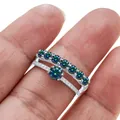 Silver moissanite ring set featuring a round solitaire and V-shaped band on a model hand - Size 5 / Rainbow