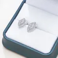 Macro shot of marquise-cut moissanite silver stud earrings with S925 hallmark - Stud Earrings / Gold