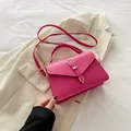 Fuchsia pink square handbag with metal buckle and adjustable strap on beige suit - Rose Pink