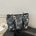 Large floral skull print tote bag with silver chain straps on a leather base - Green