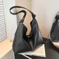 Minimalist black soft PU leather tote bag with stylish knotted shoulder strap detail - Black