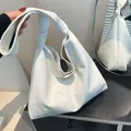 White textured leather hobo bag with unique knotted shoulder strap for women - White