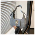 Detail of light blue crescent bag featuring golden SS logo and fringe tassel ornament - Light Blue