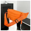 Close-up of bright orange nylon crossbody waist bag with woven zipper pull detail - Orange Red
