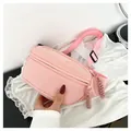 Pink nylon crossbody waist bag with woven zipper pull and adjustable shoulder strap - Pink