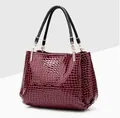 Elegante borsa a mano bordeaux con trama a coccodrillo, manici neri e dettagli dorati - Rosso