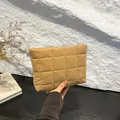 Close-up of a quilted khaki velvet makeup bag with soft padded texture and elegant stitching - Khaki