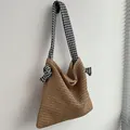 Khaki woven straw shoulder bag with stylish black and white houndstooth knotted strap - Brown