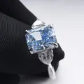 3 carat radiant cut light blue stone ring with heart side stones in silver claw setting - Size 5 / Blue