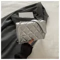 Detail of silver quilted crossbody bag with metal chain strap and luxury texture - Silver