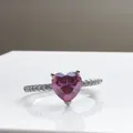 Pink heart-shaped 1ct moissanite ring with a diamond-pave band on white reflection surface - Size 5 / Pink (1 Carat)