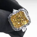 Radiant cut 10-carat yellow carbon diamond ring with side trillion stones in halo setting - Size 5 / Yellow