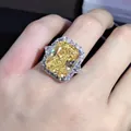 Radiant cut yellow carbon diamond ring with silver side stones on hand display - Size 5 / Yellow