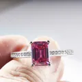 S925 silver ring with radiant cut emerald shape magenta moissanite held by fingers - Size 5 / Pink (2 Carat)
