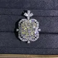 Detailed macro view of radiant cut yellow gemstone pendant with double halo diamond accents - White