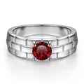 Detailed view of silver watch-band style ring featuring a red center stone and brick pattern - Garnet Red