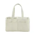 Detail view of corduroy diaper bag with internal dividers and soft ribbed texture - White