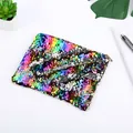 Detail shot of a colorful reversible sequin pencil case on a clean desktop setup - Rainbow+Silver
