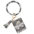 Detail view of snakeskin pattern card holder keychain with tassel and gold hardware - Off Black