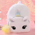 Detail of plush unicorn backpack with soft white faux fur and rainbow horn accent - White