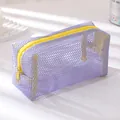Detail of purple mesh pencil case with yellow zipper contrast and nylon net texture - Violet