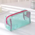 Macro view of mint green mesh pencil case with pink zipper on a clean white base - Light Blue
