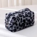 Detailed view of the soft leopard print faux fur plush makeup bag with silver zipper closure - Gray