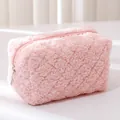 Close-up of pink plush pencil case with soft grainy texture and silver metal zipper detail - Pink
