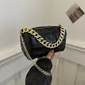 Chic black quilted crossbody bag with golden chunky chain and elegant texture - Black