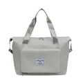 Detail view of large capacity waterproof gym bag with front zipper pocket and carry handles - Gray