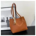 Detail of caramel tote bag with decorative fashion ribbon and vertical stitching - Tan