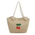 Woven straw tote bag in light beige featuring red cherry embroidery and white rope handles - Khaki