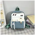 Détail du sac à dos scolaire bleu et blanc avec pendentif animal et poches zippées - Vert